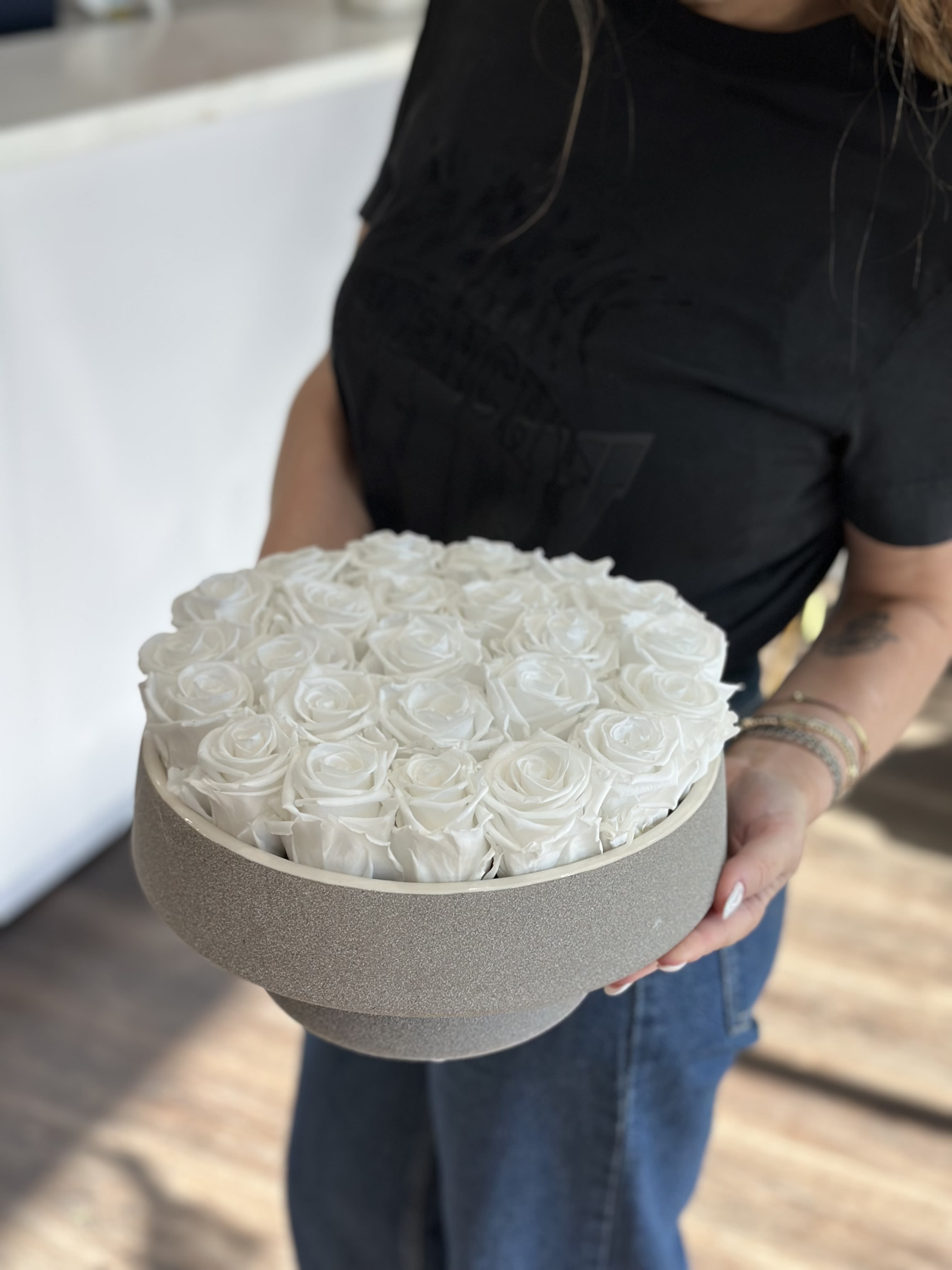 Round box filled with white roses