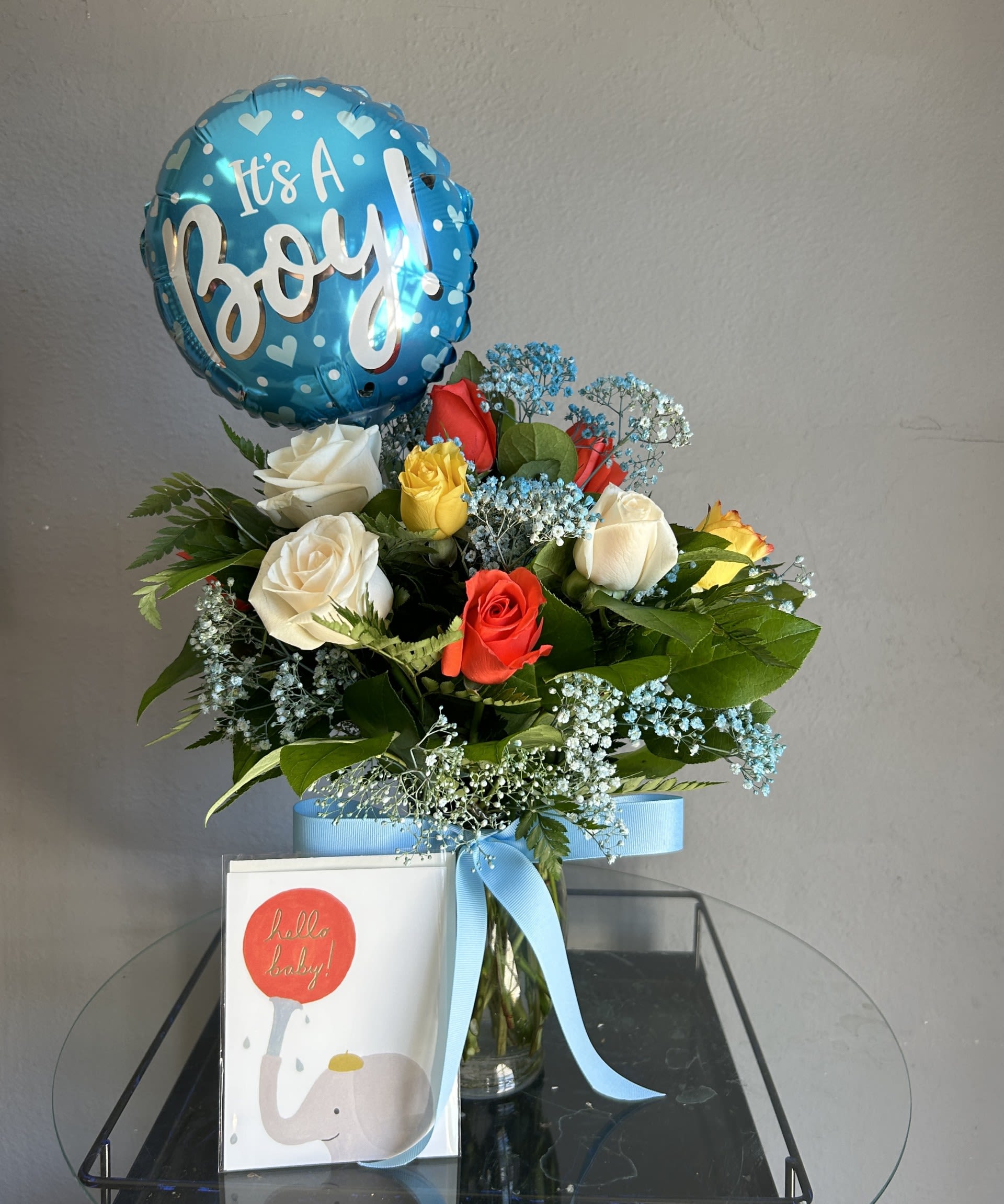 Welcome Baby Boy Package! - Your choice of a dozen, 1.5, or two dozen masculine colored roses with blue babys breath arranged in a vase. Comes with It's a Boy! Balloon and handwritten hello baby card with your card message written inside. Such a perfect gift to welcome loved ones to parenthood!