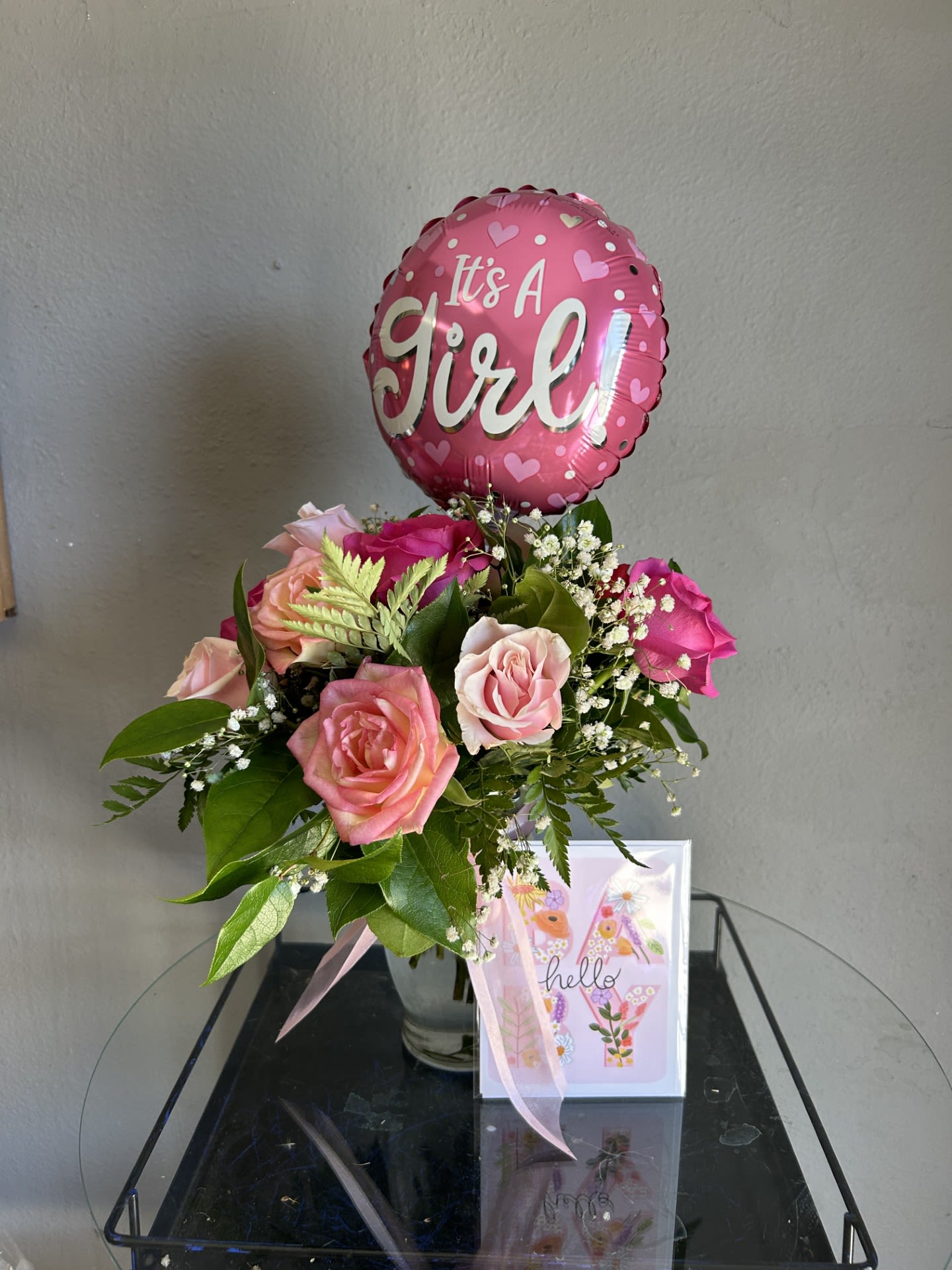 Welcome Baby Girl Package! - Your choice of a dozen, 1.5, or two dozen feminine colored roses with babys breath arranged in a vase. Comes with It's a Girl! Balloon and handwritten hello baby card with your card message written inside. Such a perfect gift to welcome loved ones to parenthood!