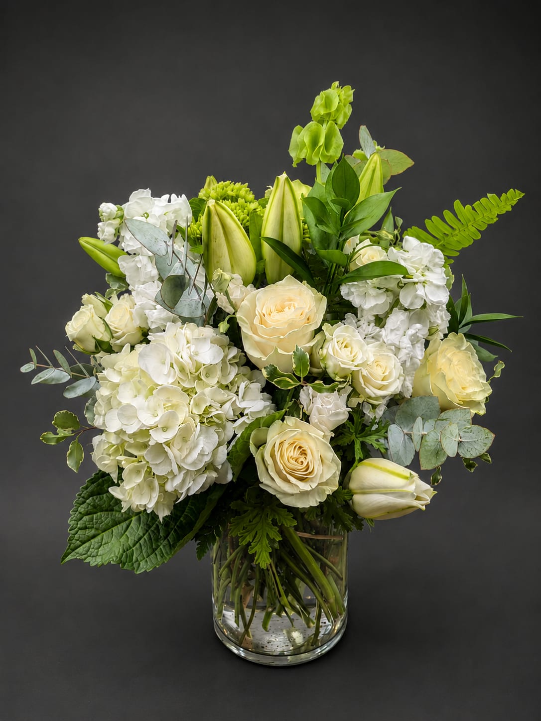 White and cream floral arrangement in a clear glass vase