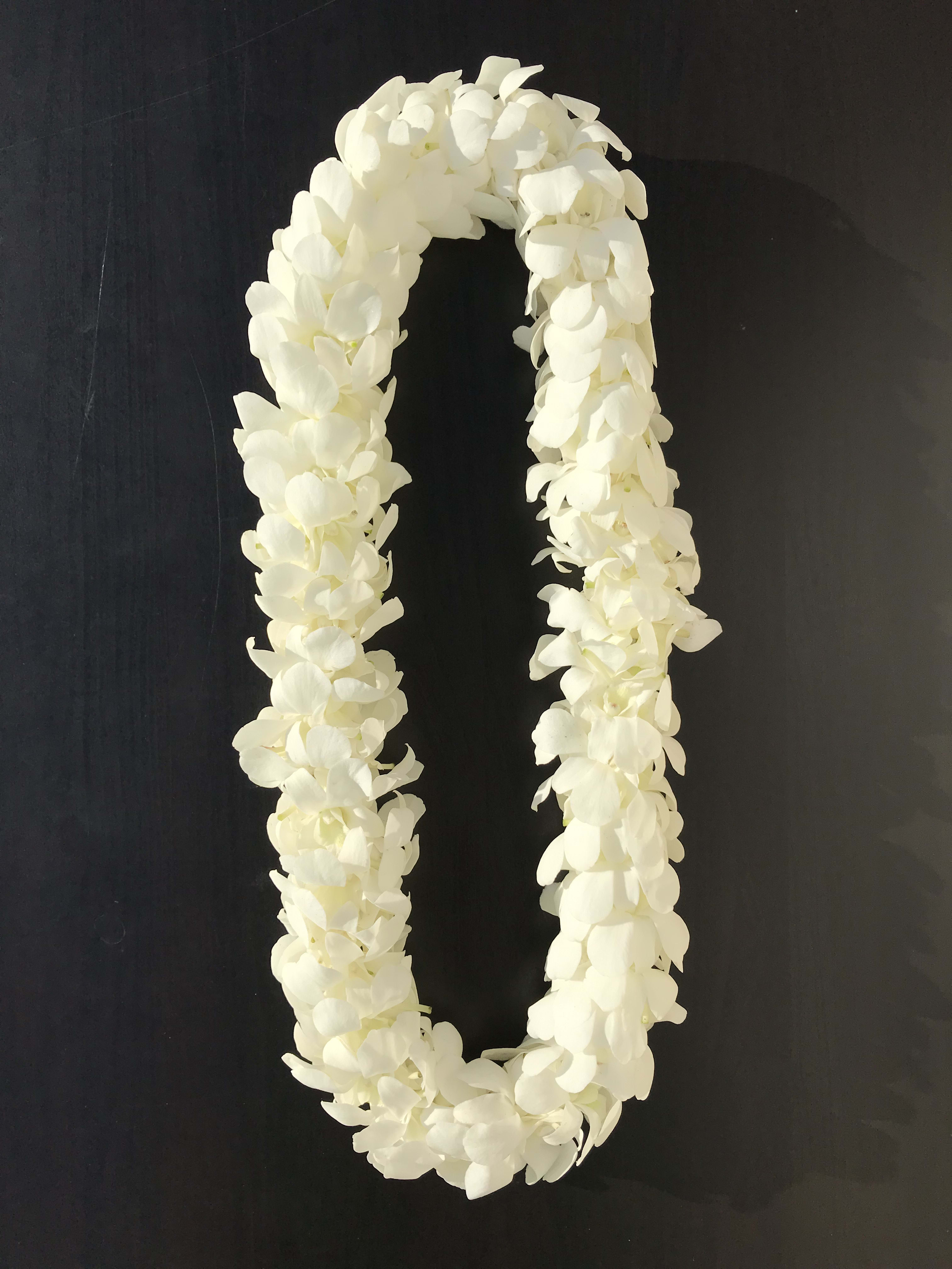 White flower lei on a dark background