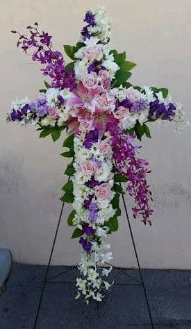 Cross-shaped floral standing spray with pink, white, and purple flowers