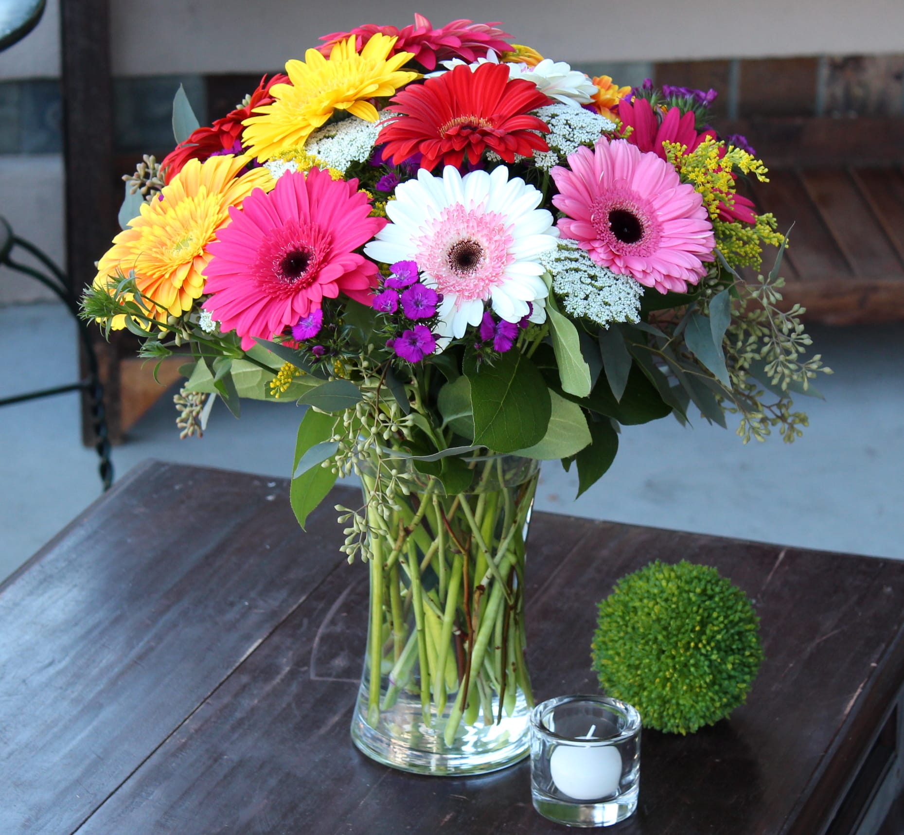 Colorful gerbera daisy bouquet in a clear glass vase