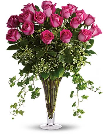Long Stemmed Pink Roses - Make a statement! This lush arrangement of hot pink roses and gracefully trailing ivy can be a fabulously romantic gift, or a fun-filled gift for a girlfriend. Eighteen hot pink roses rise elegantly above dense greenery including ivy, pitta negra and salal. Delivered in a classic footed flared vase.