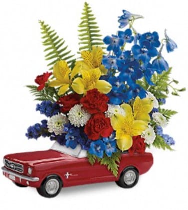Red toy car holding a colorful flower arrangement