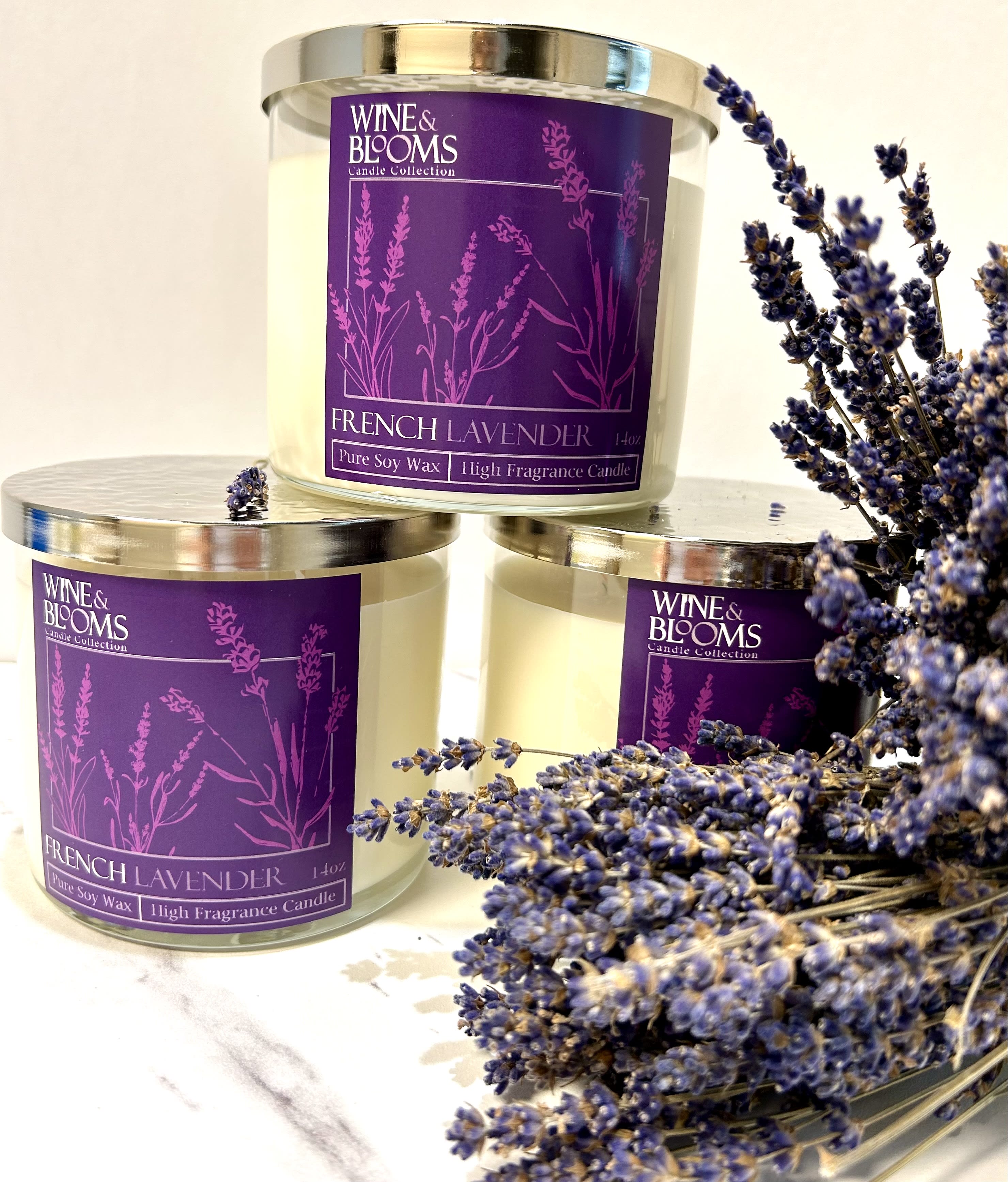 Three lavender-scented candles with a sprig of dried lavender