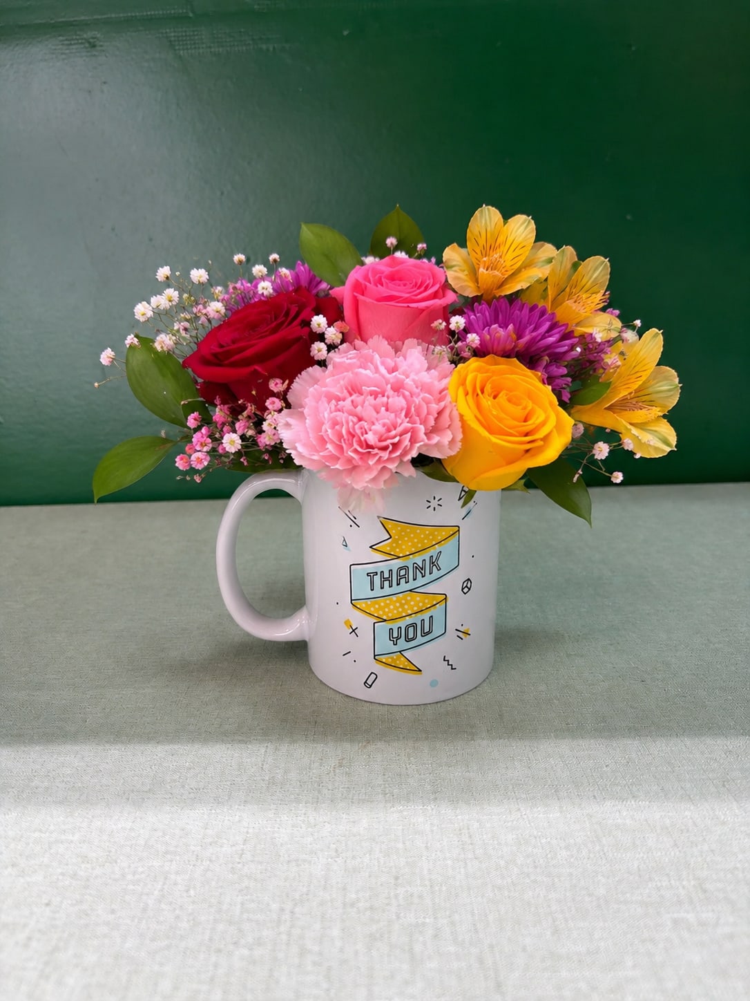 Mixed bouquet in a white mug with a thank-you design
