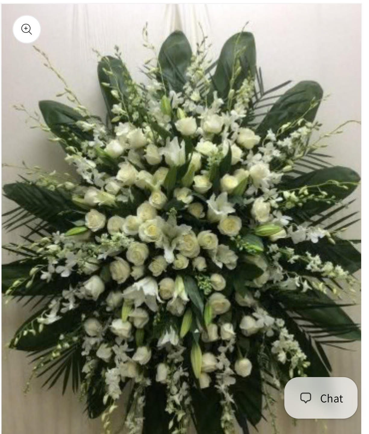 Large white floral standing spray with roses and lilies