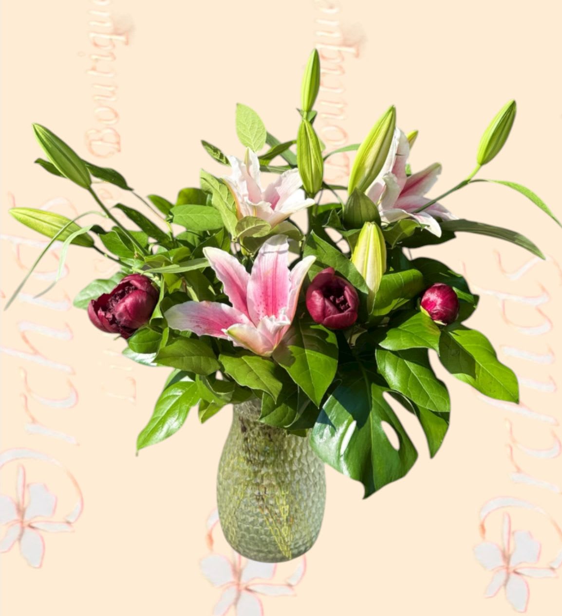 Pink lilies and dark pink tulips in a textured glass vase