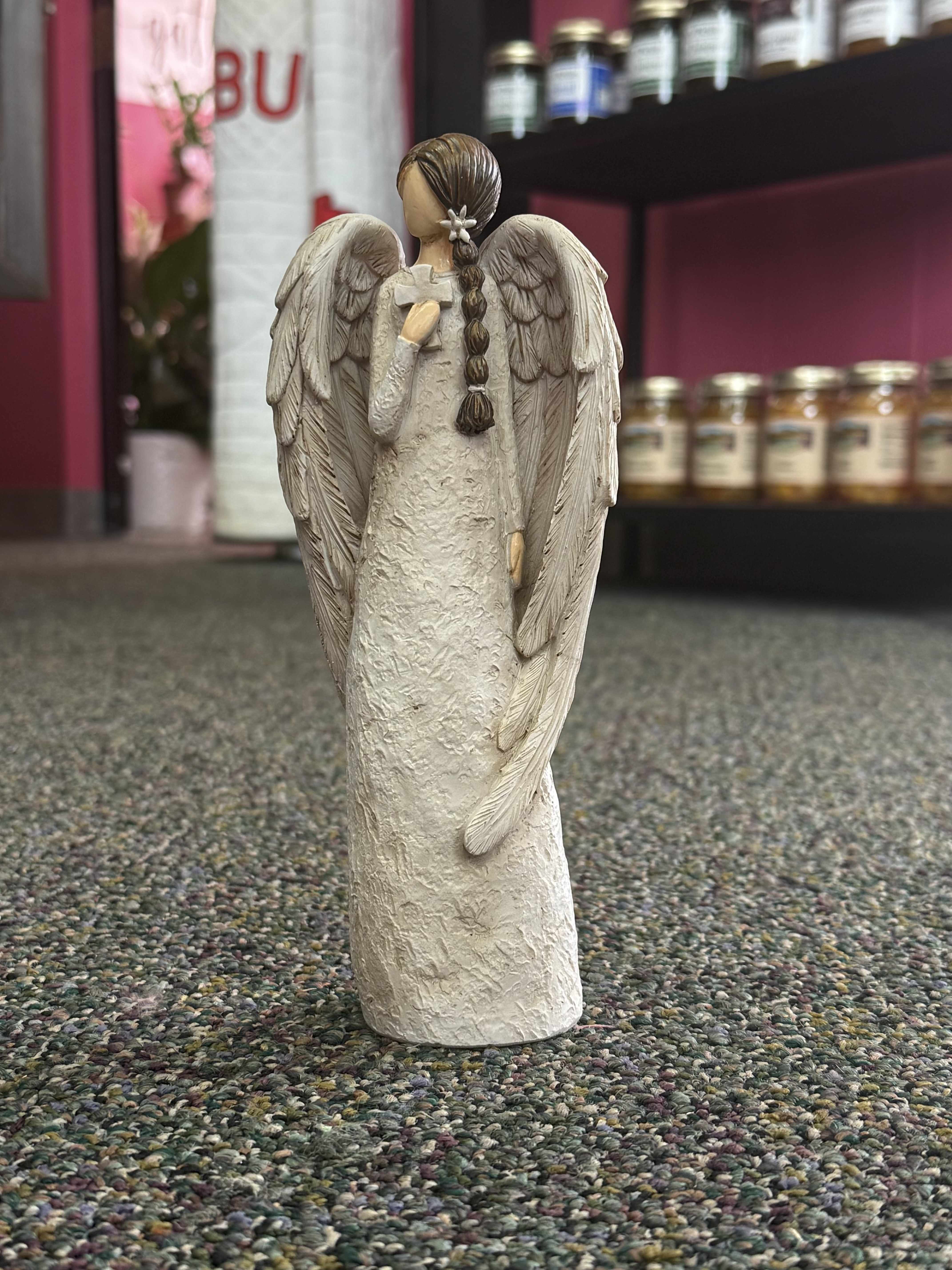 Angel figurine with large wings and braided hair