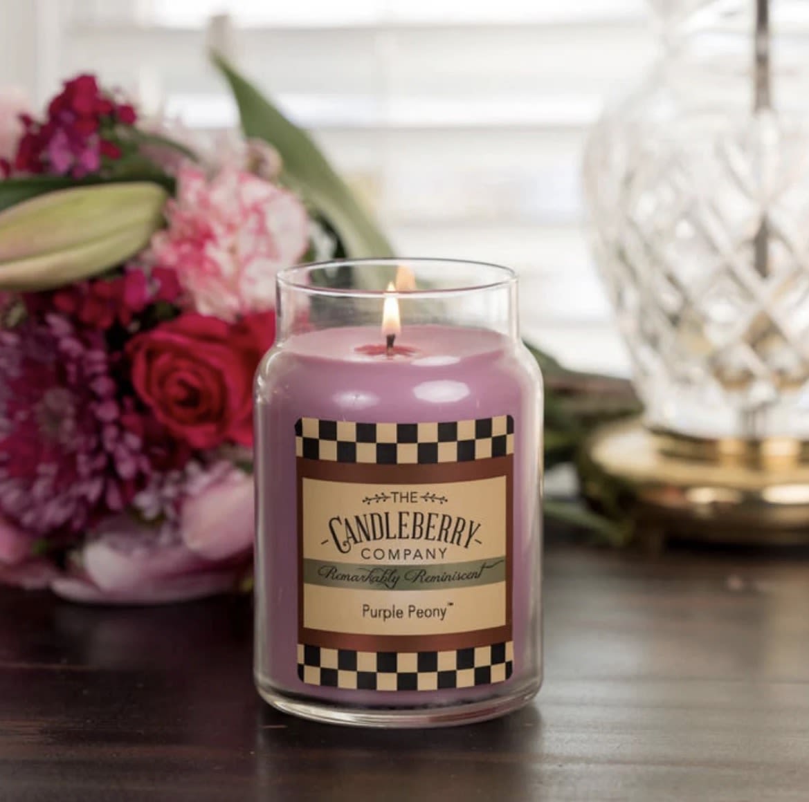 Purple Peony™ - Large Jar Candle - Description: This Purple Peony scented candle has ruby pomegranate, blush peony, and midnight jasmine are wrapped in sheer white woods with a hint of pink peppercorn.  Scent Notes: Top: Midnight Jasmine, Pink Rose Mid: Plum, Apple, Orange Flower Base: Ruby Pomegranate, Blush Peony, Musk  Product Details: Burn Time: 135-155 hours Wax Info: Soy Blend Wicks: Single wick - 100% lead-free Produced: Proudly Made in the USA Formula: Made with Advanced Fragrance Technology, Highly Scented, Clean burning