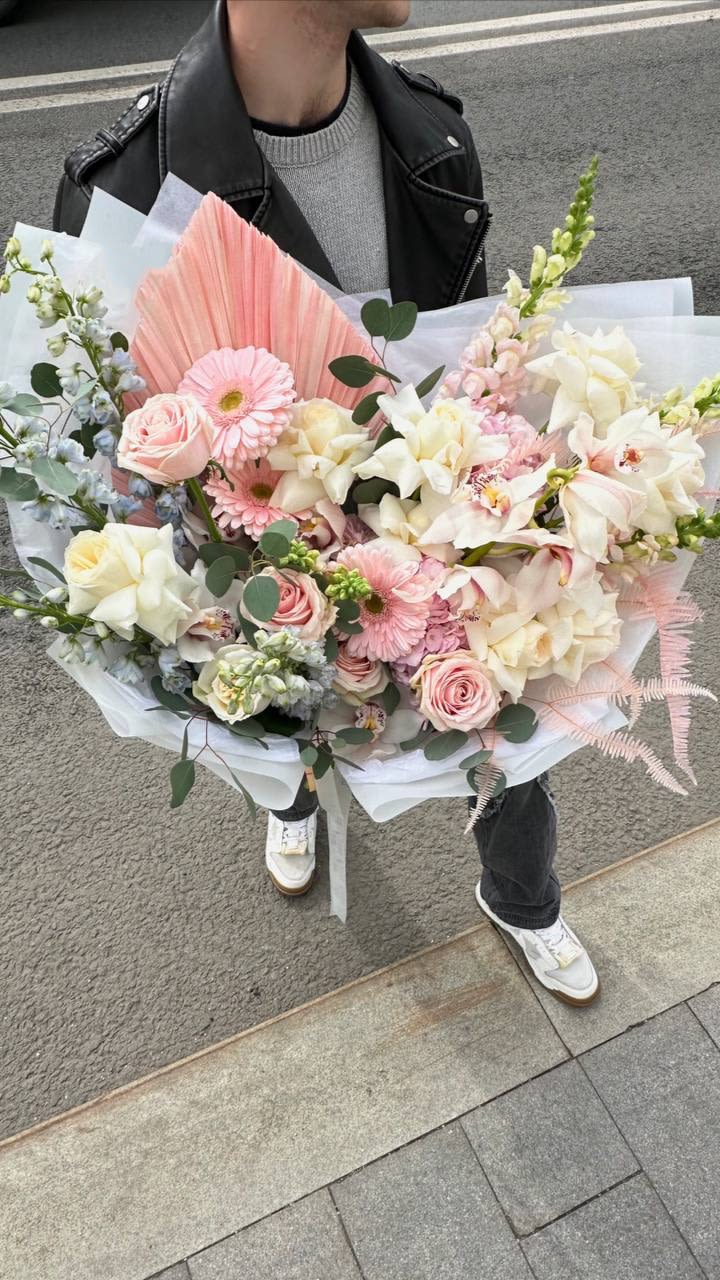 Large pastel bouquet with pink and white flowers wrapped in white paper