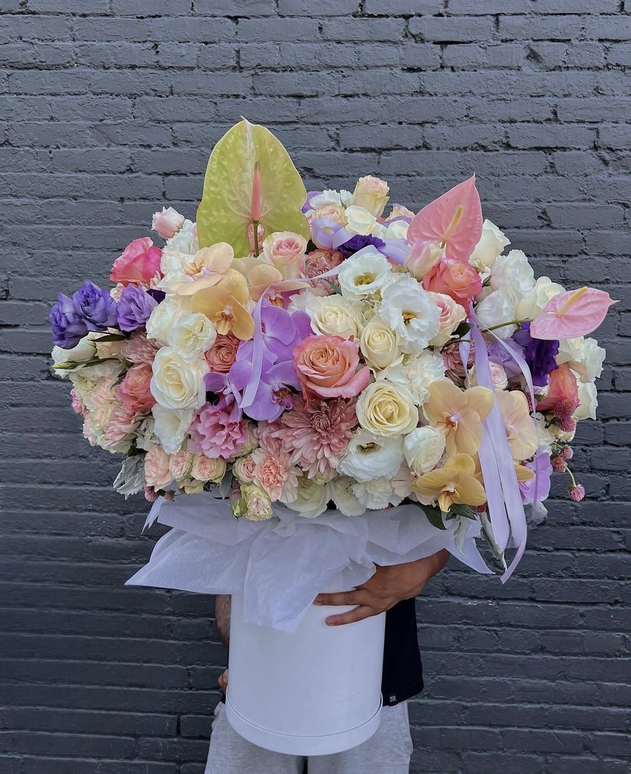 Large pastel flower arrangement in a white hat box