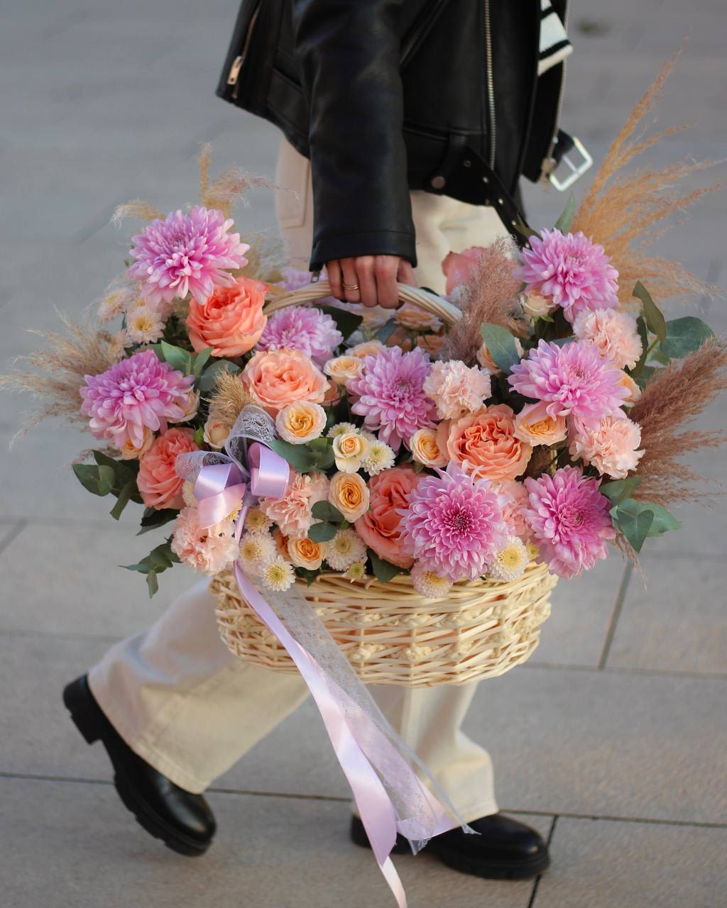 Basket of pink and peach flowers with a lavender ribbon