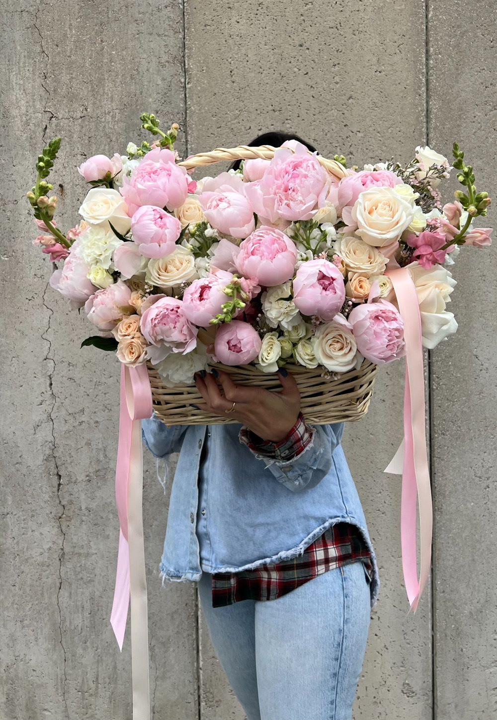 Large basket of pink and white flowers with ribbon streamers
