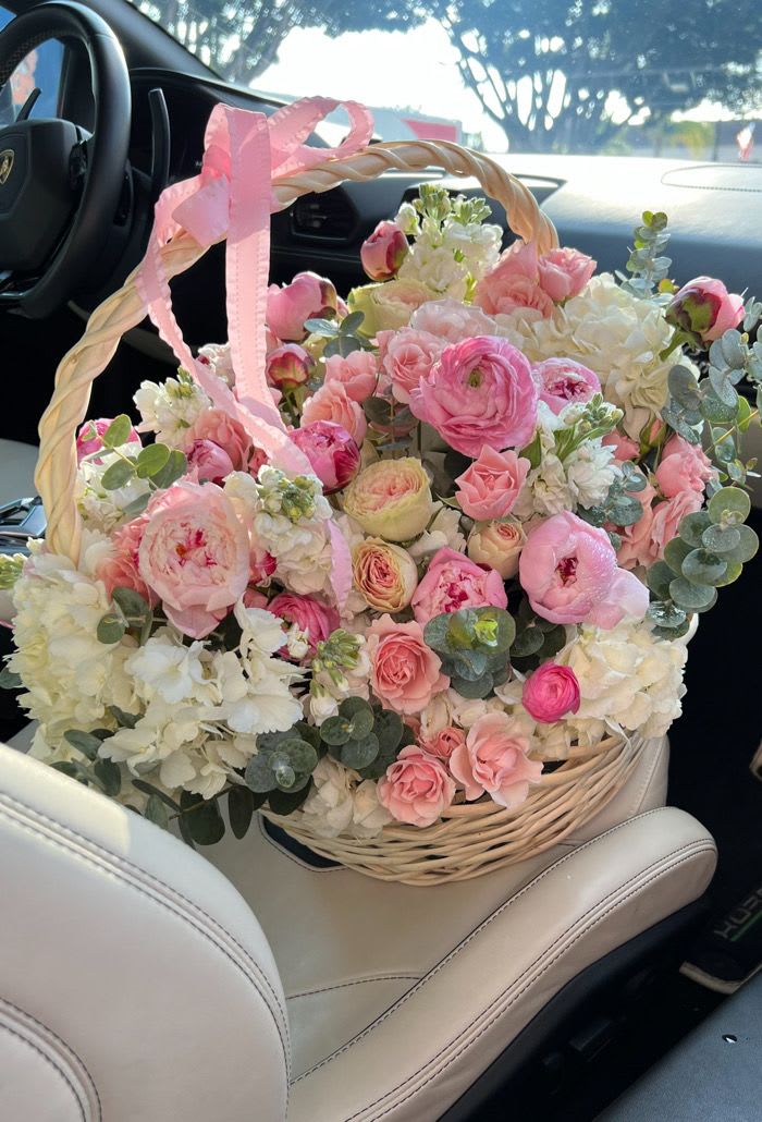 Pink and white flower basket with a ribbon handle