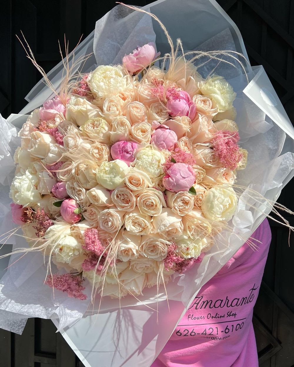 Large bouquet of blush and cream roses with pink accents