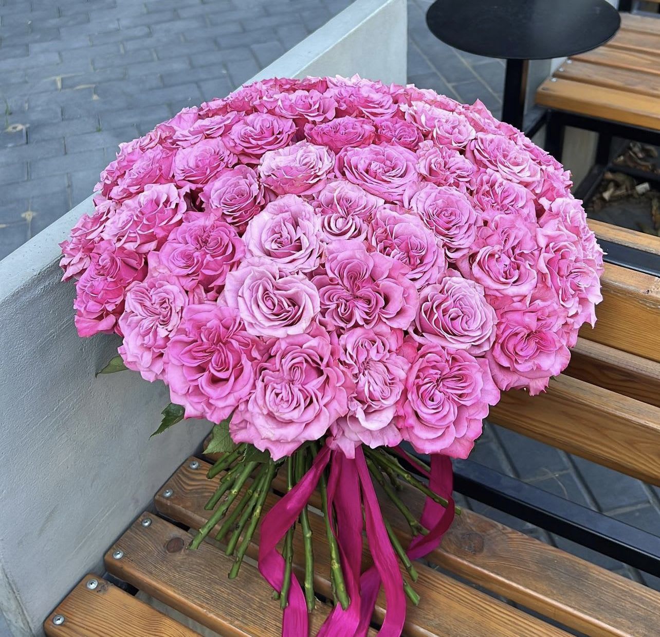 Large bouquet of pink roses tied with a magenta ribbon