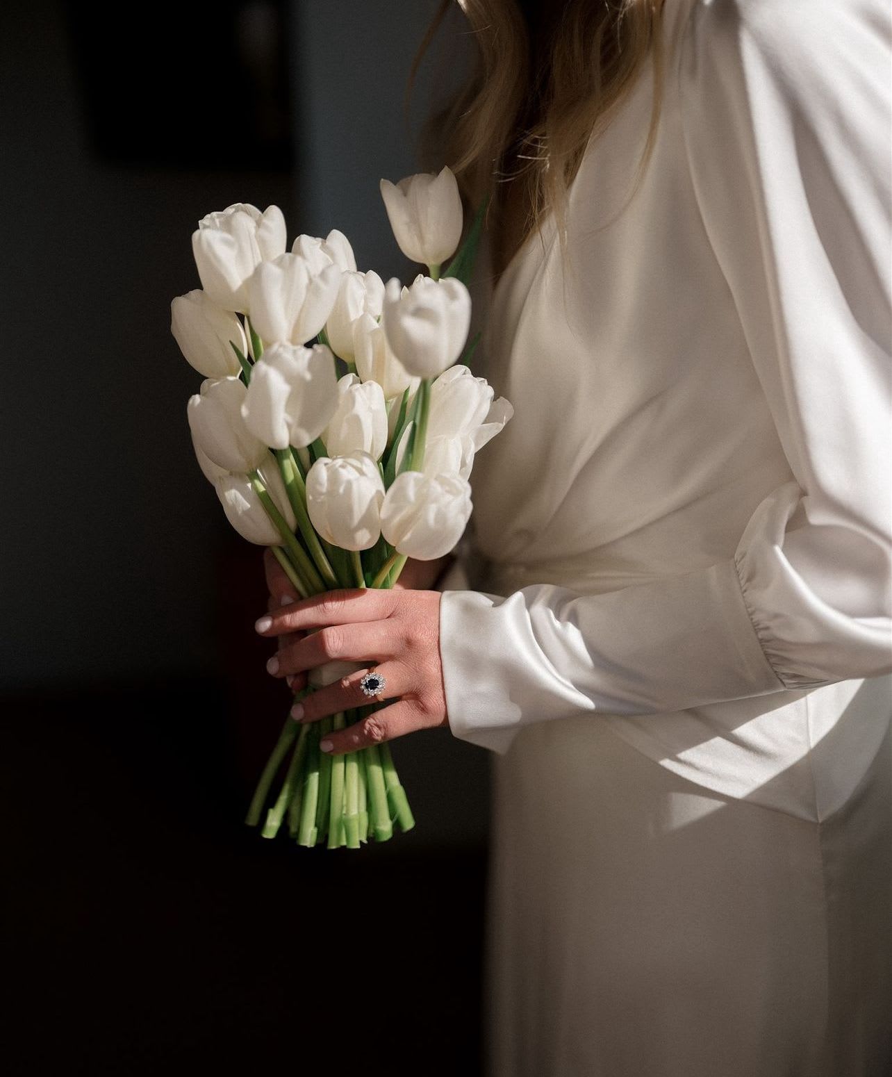 Woman holding a bouquet of white tulips