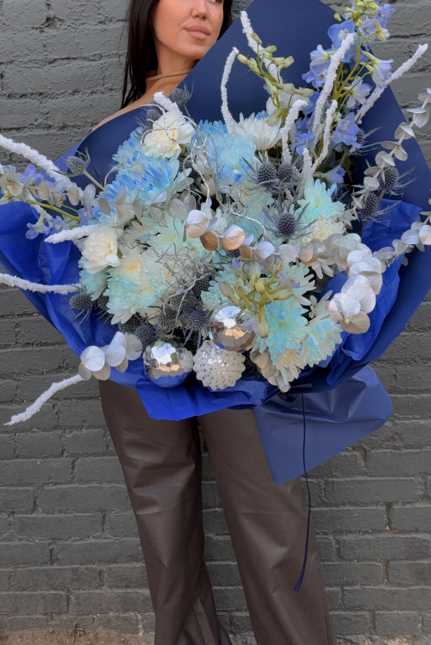 Large blue bouquet with pale flowers and silver accents