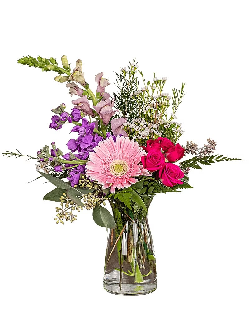 Mixed pink and purple flowers in a clear glass vase