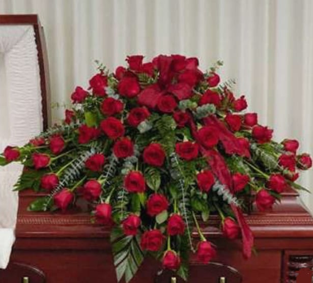 Large spray of red roses on a casket