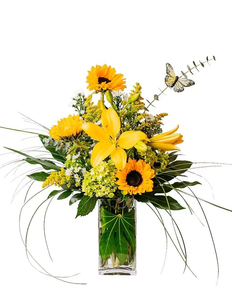 Taking Flight - Lift their spirits high. Taking Flight's sunny yellows will have them soaring with happiness. Yellow lilies, sunflowers and other flowers are playfully arranged in this sunny arrangement. 