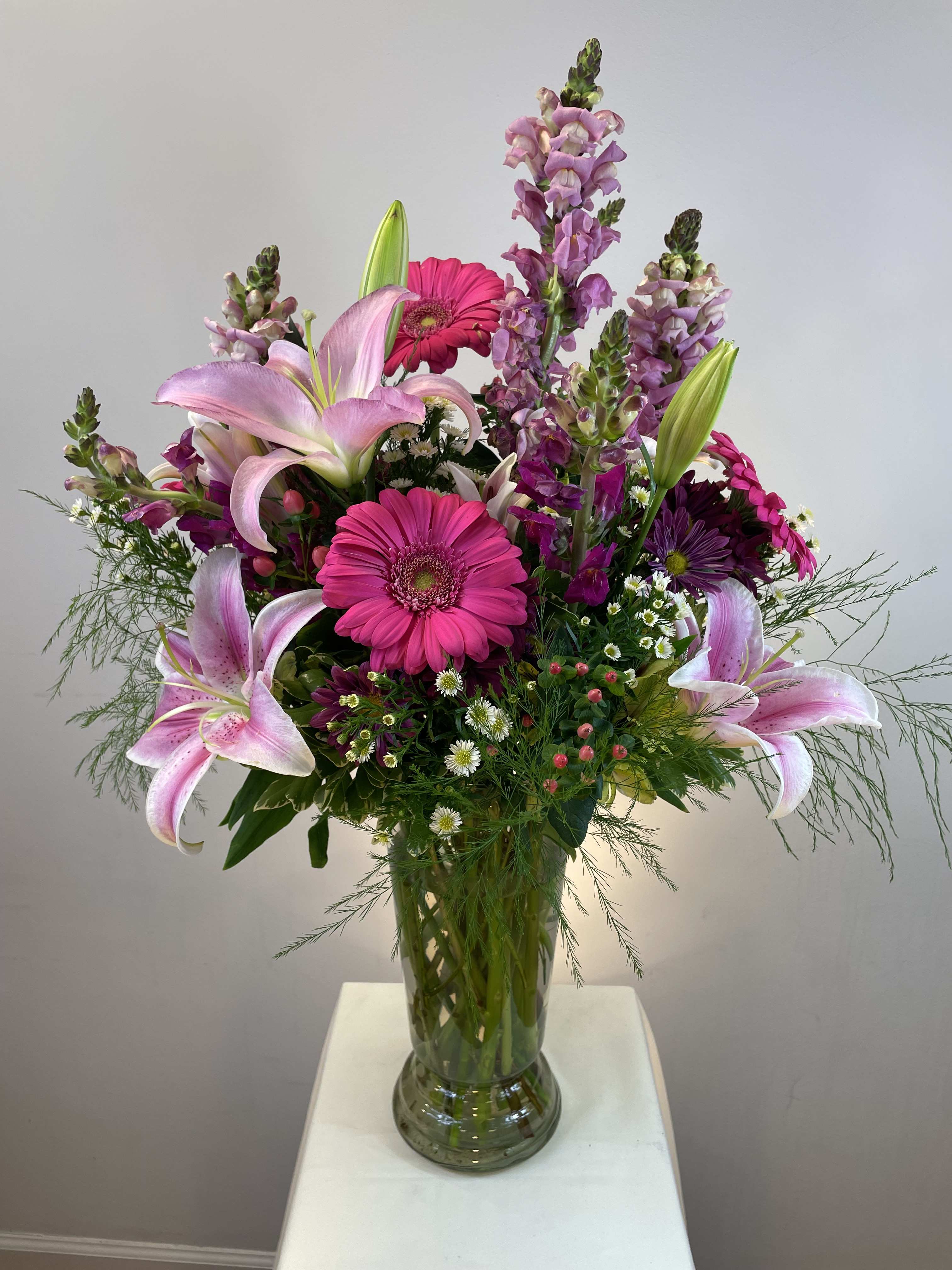 Pink lilies and gerbera daisies in a glass vase