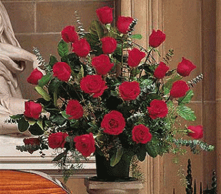 Tall fan-shaped arrangement of red roses in a black container