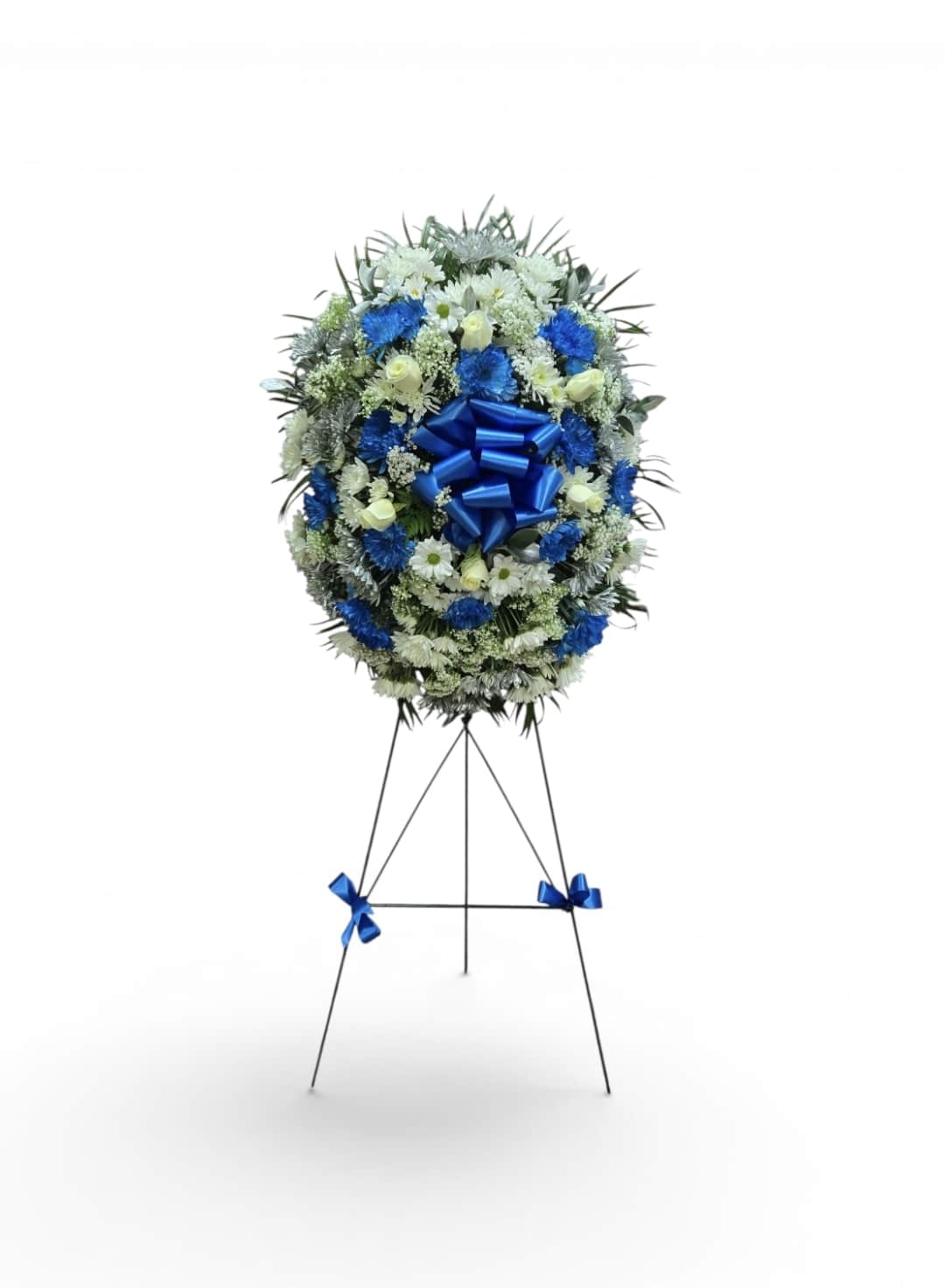 Blue and white funeral wreath on a standing easel with ribbon
