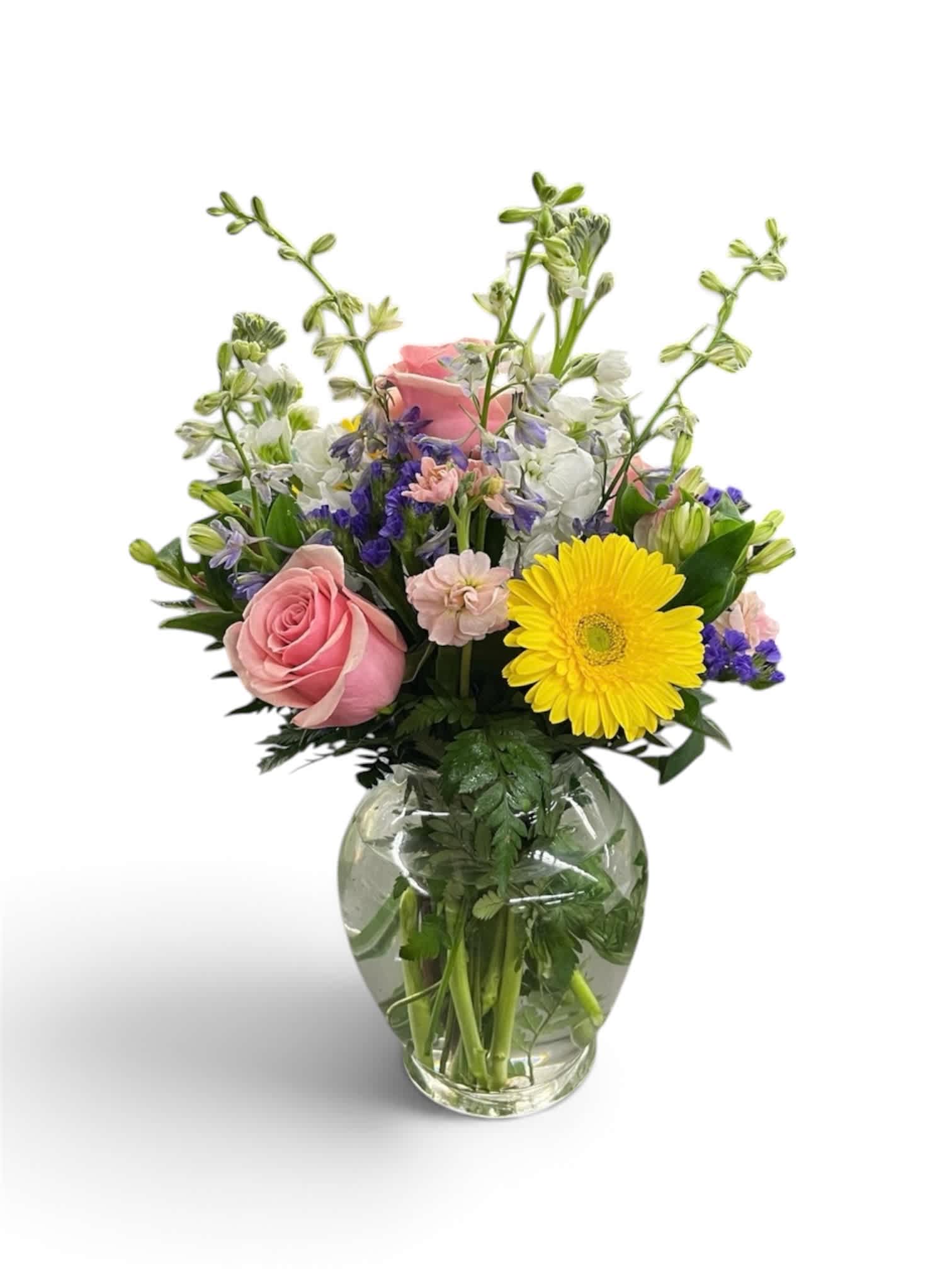 Mixed bouquet in a clear glass vase with pink roses and a yellow gerbera daisy