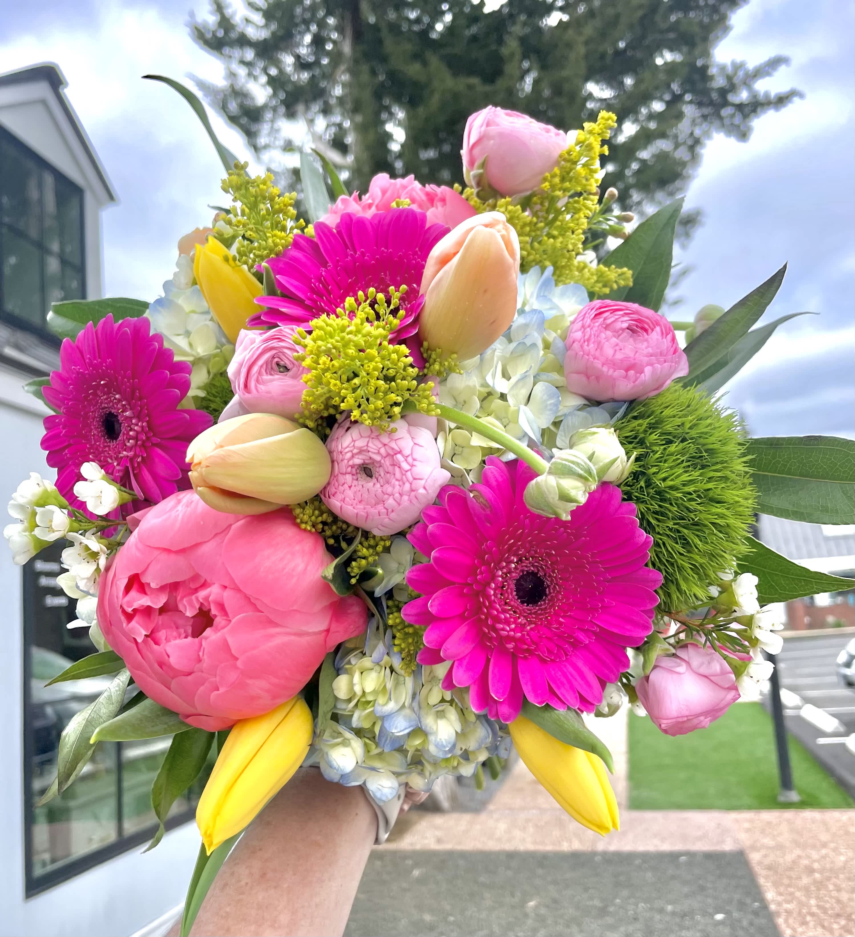 Bright bouquet of pink gerbera daisies, tulips, and peonies