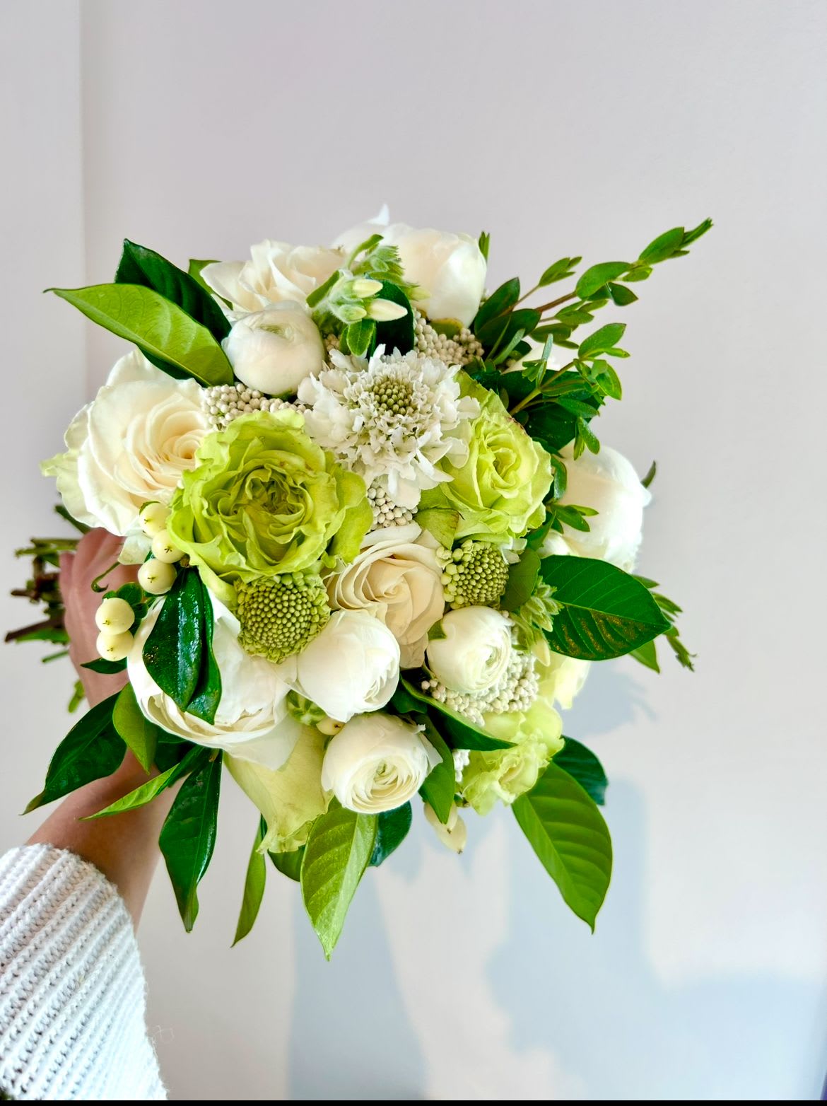 The Green &amp; White Delight Bouquet - Crisp and green yet shining with beauty! The green &amp; white delight is a gorgeous bouquet of fresh whites and greens. White ranunculus, green roses, white roses, some smaller white flowers like orlea or late flowers blends well with shiny gardenia leaves &amp; a kiss of eucalyptus.  The Standard &amp; Deluxe Arrangements are bouquet style wrapped &amp; ribboned. The premium version comes low and lush vased. 