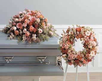 Floral casket spray and wreath in pink and peach tones