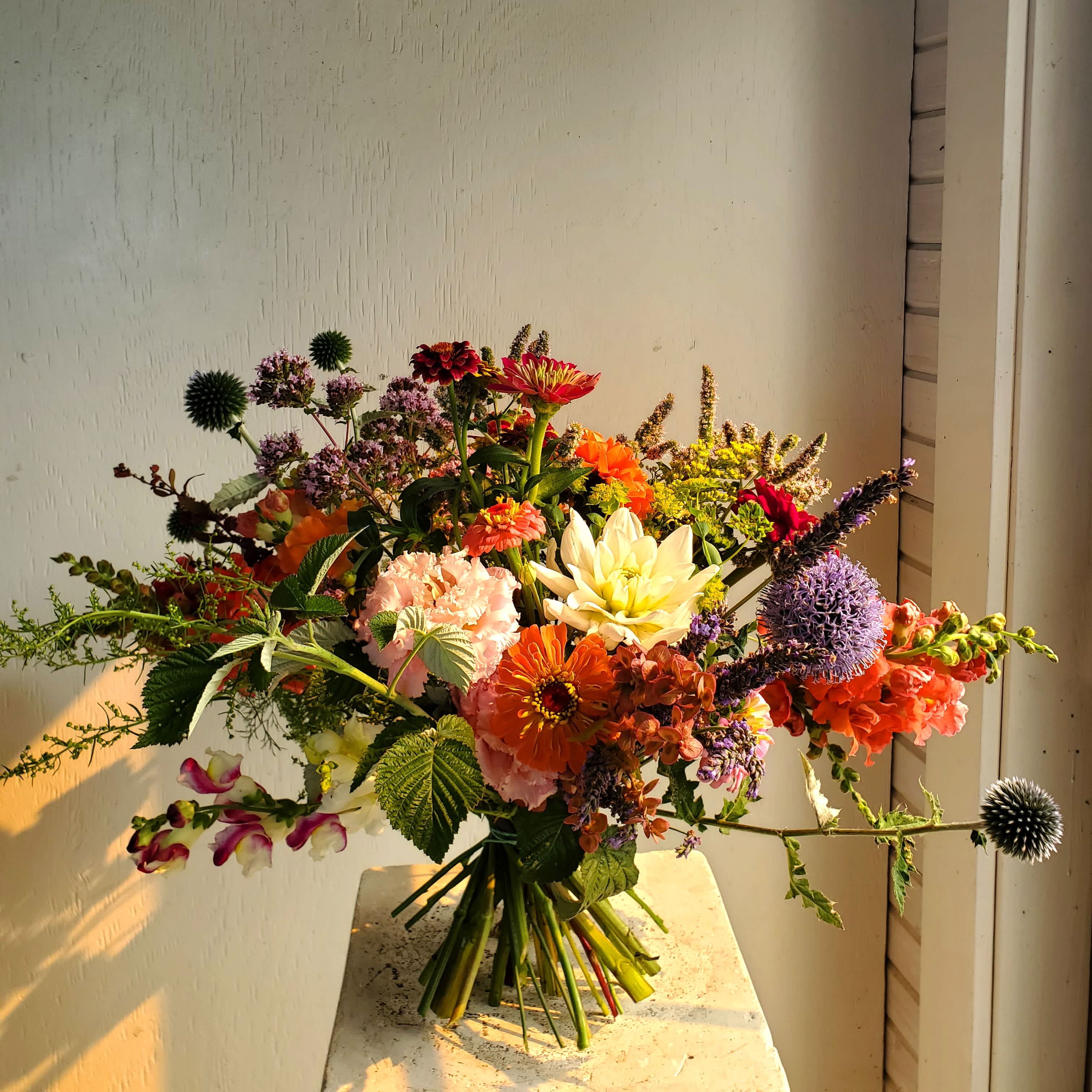 Colorful mixed bouquet with orange, pink, purple, and white flowers