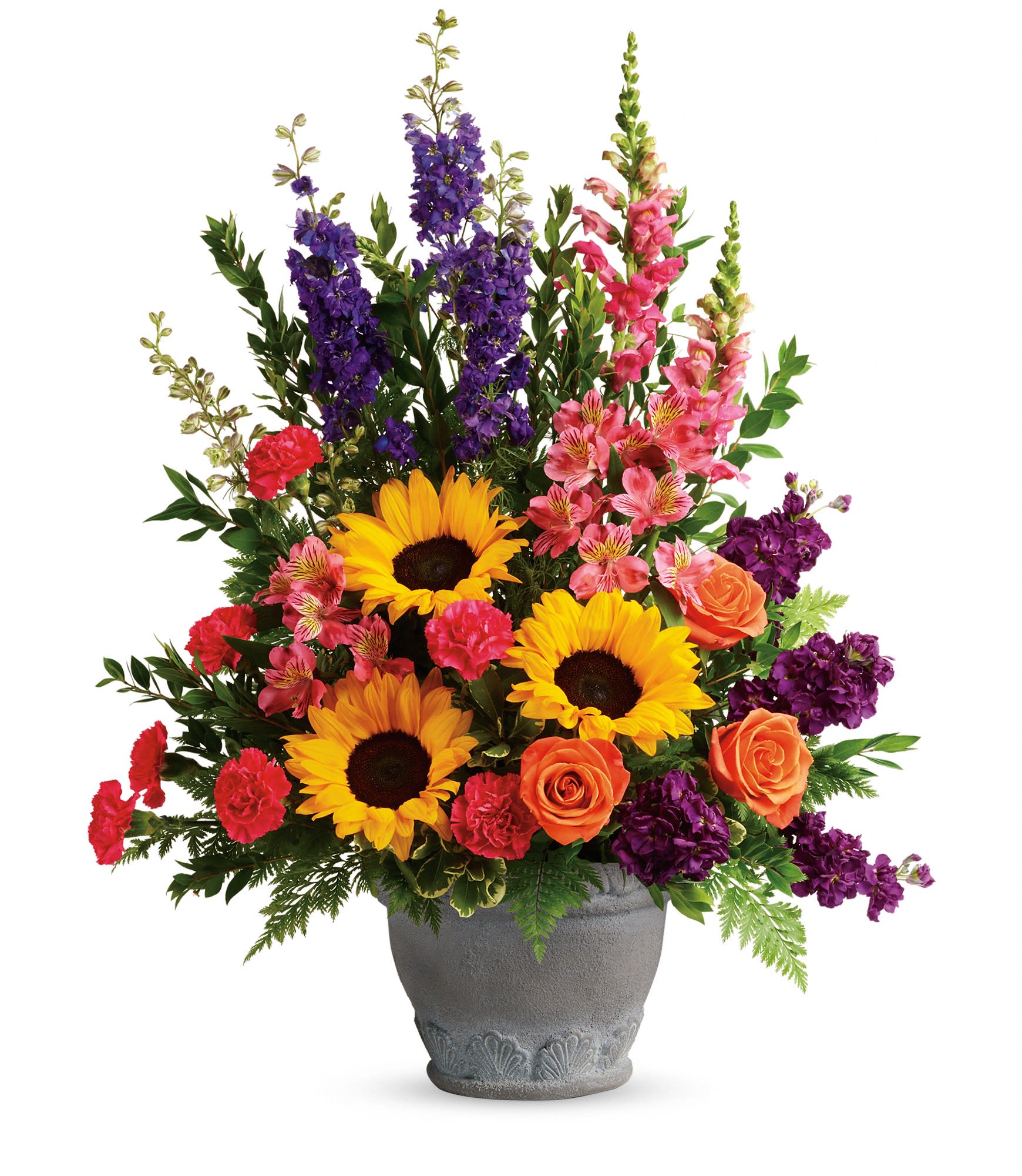 Mixed bouquet with sunflowers, roses, and purple blooms in a gray vase