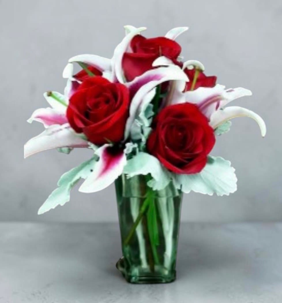 Roses and Stargaziers - Our premium red roses are accented with the fragrance of these beautiful stargazer lilies nestled in a beautiful glass vase. Makes a perfect gift to set on her desk at the office for any occasion.   
