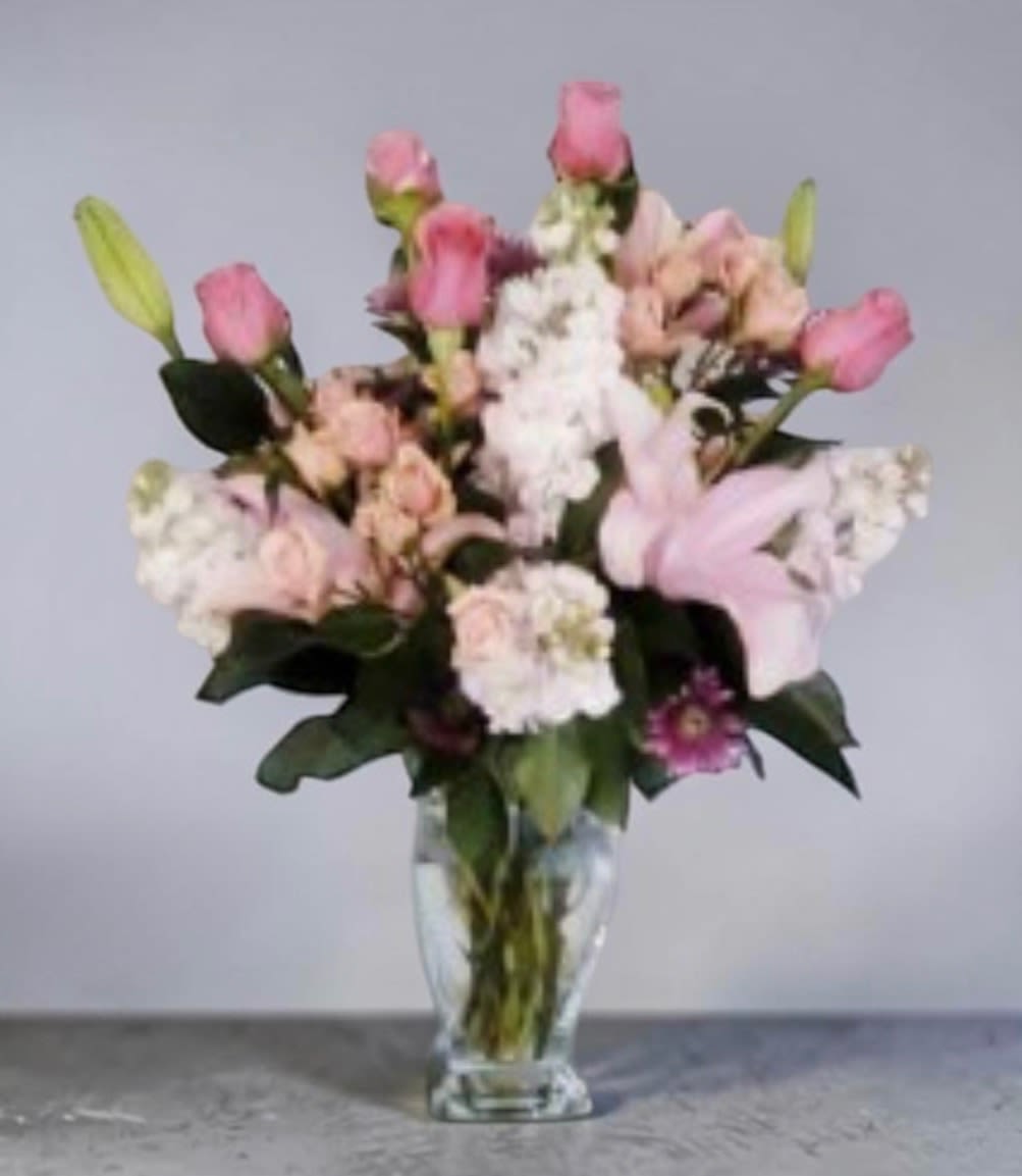 Pink Passion - This beautiful arrangement will fill the room with a scent she will never forget.  consist of roses, stock, lilies and other beautiful blooms. 