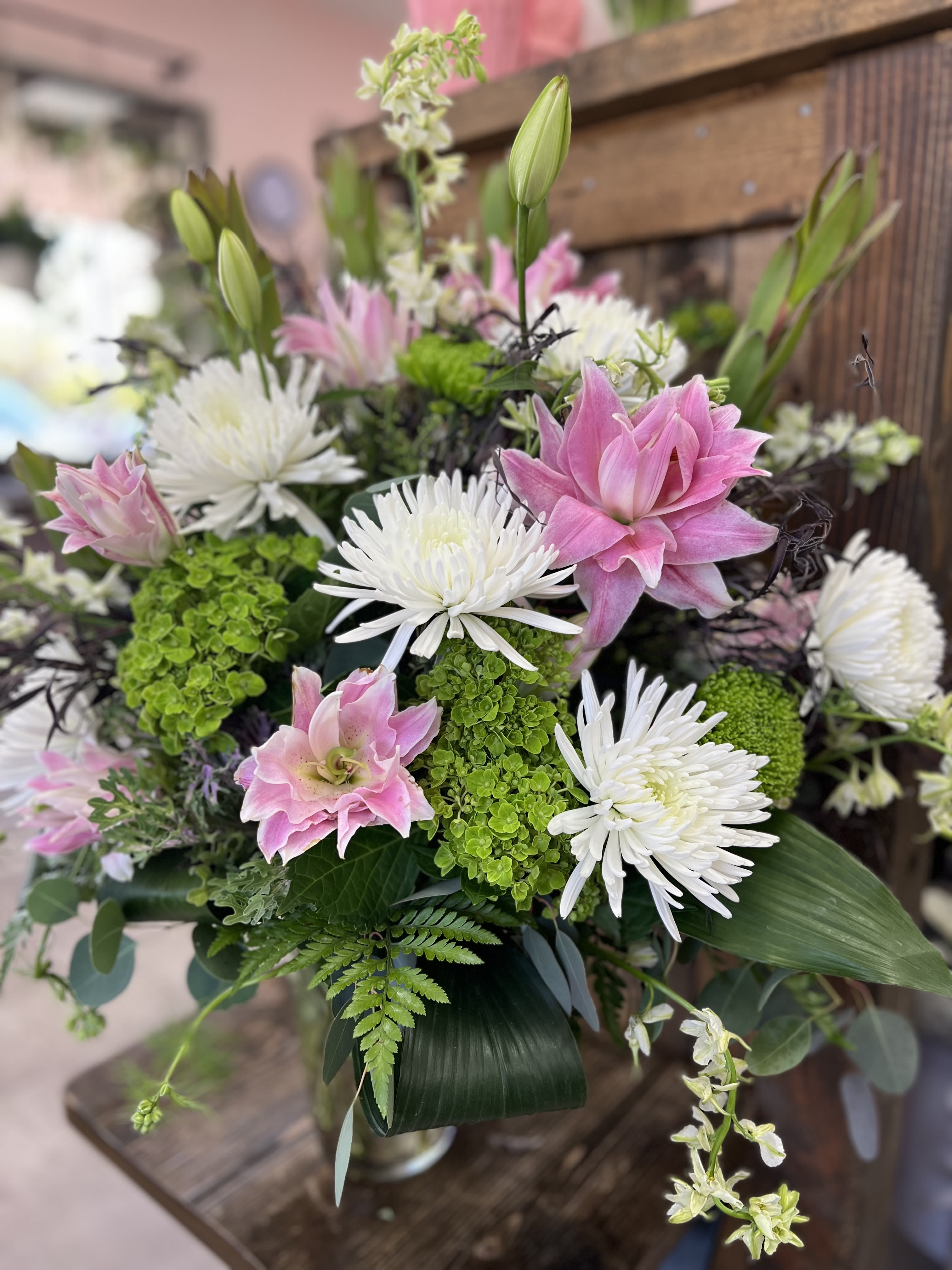 Pink and white floral arrangement with spider mums and lilies