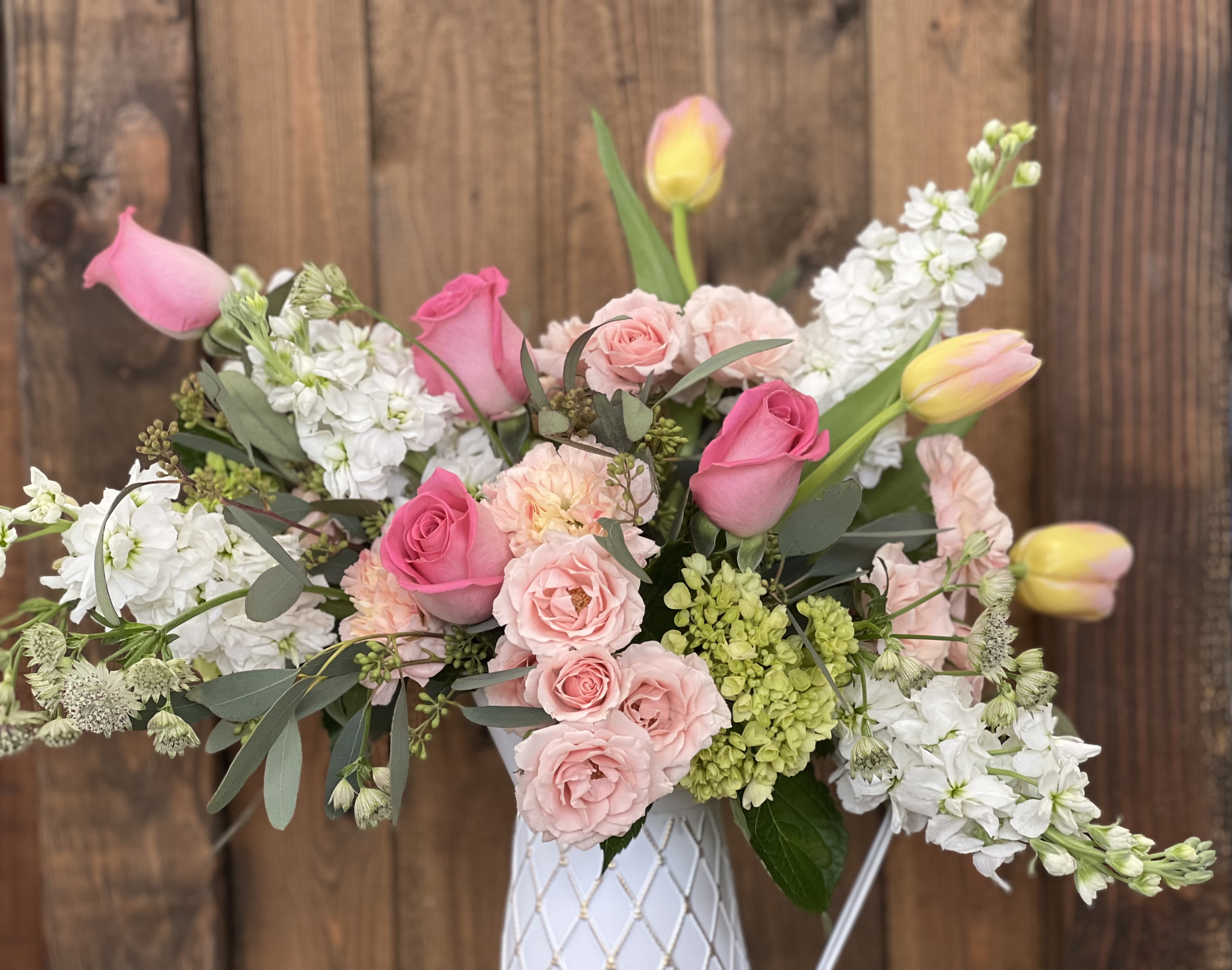Pink and white flower arrangement in a white vase