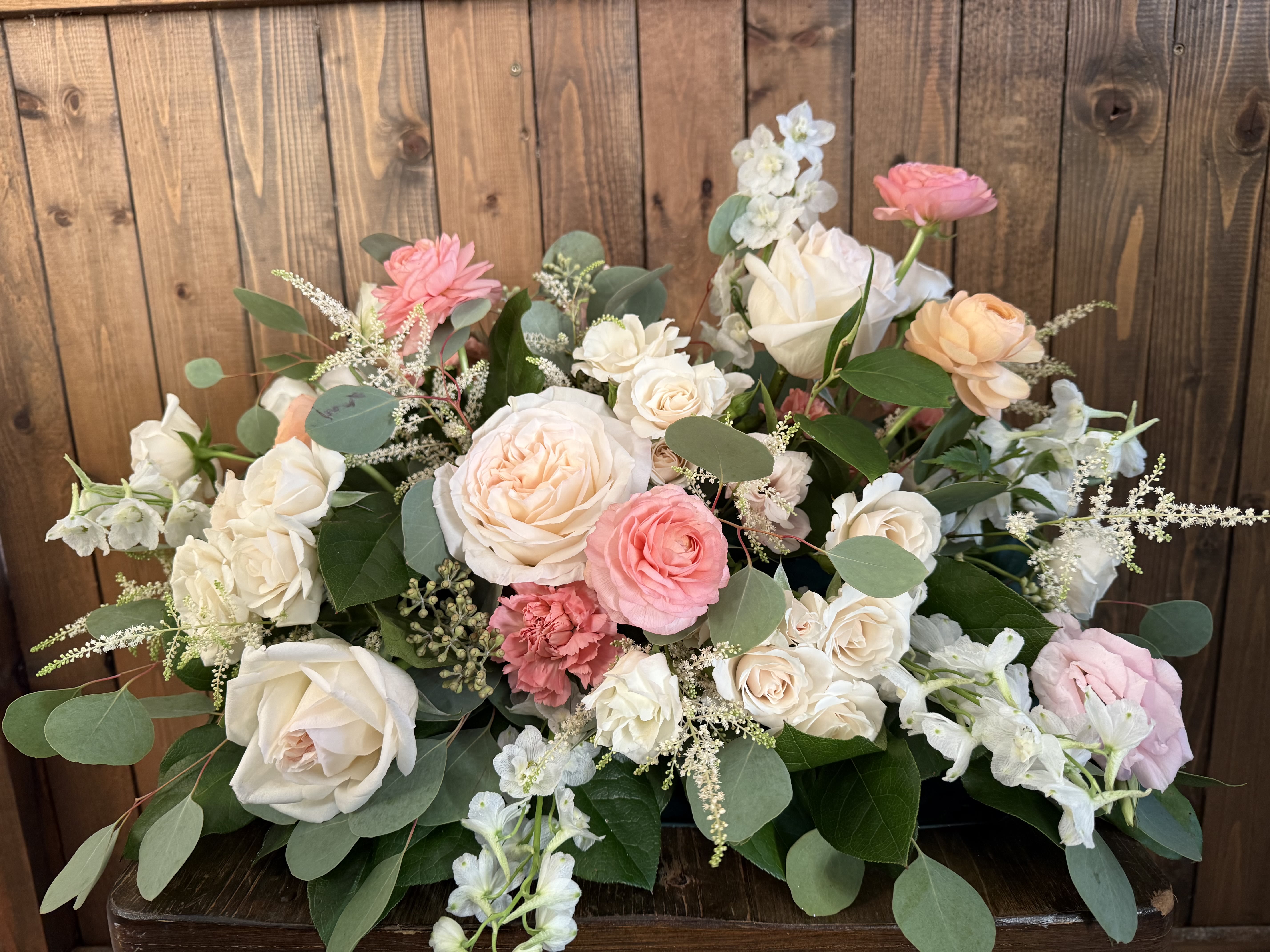 Pastel rose arrangement with white and pink blooms in a low design