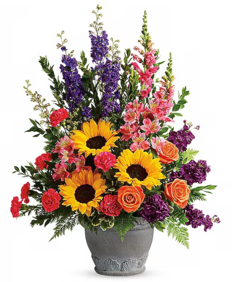 Colorful mixed flower arrangement in a gray vase with sunflowers and roses