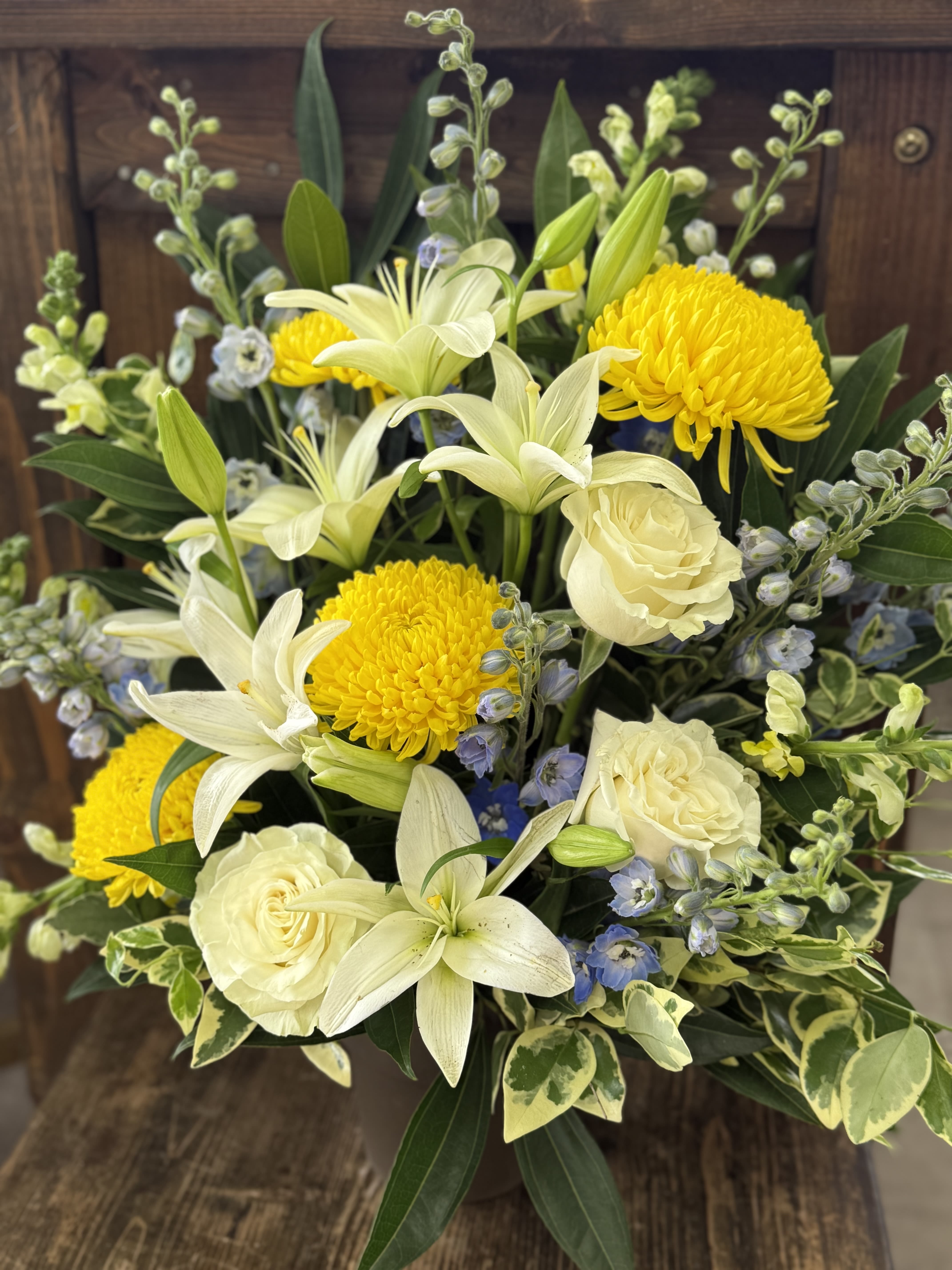 Bouquet of white lilies, cream roses, and yellow chrysanthemums