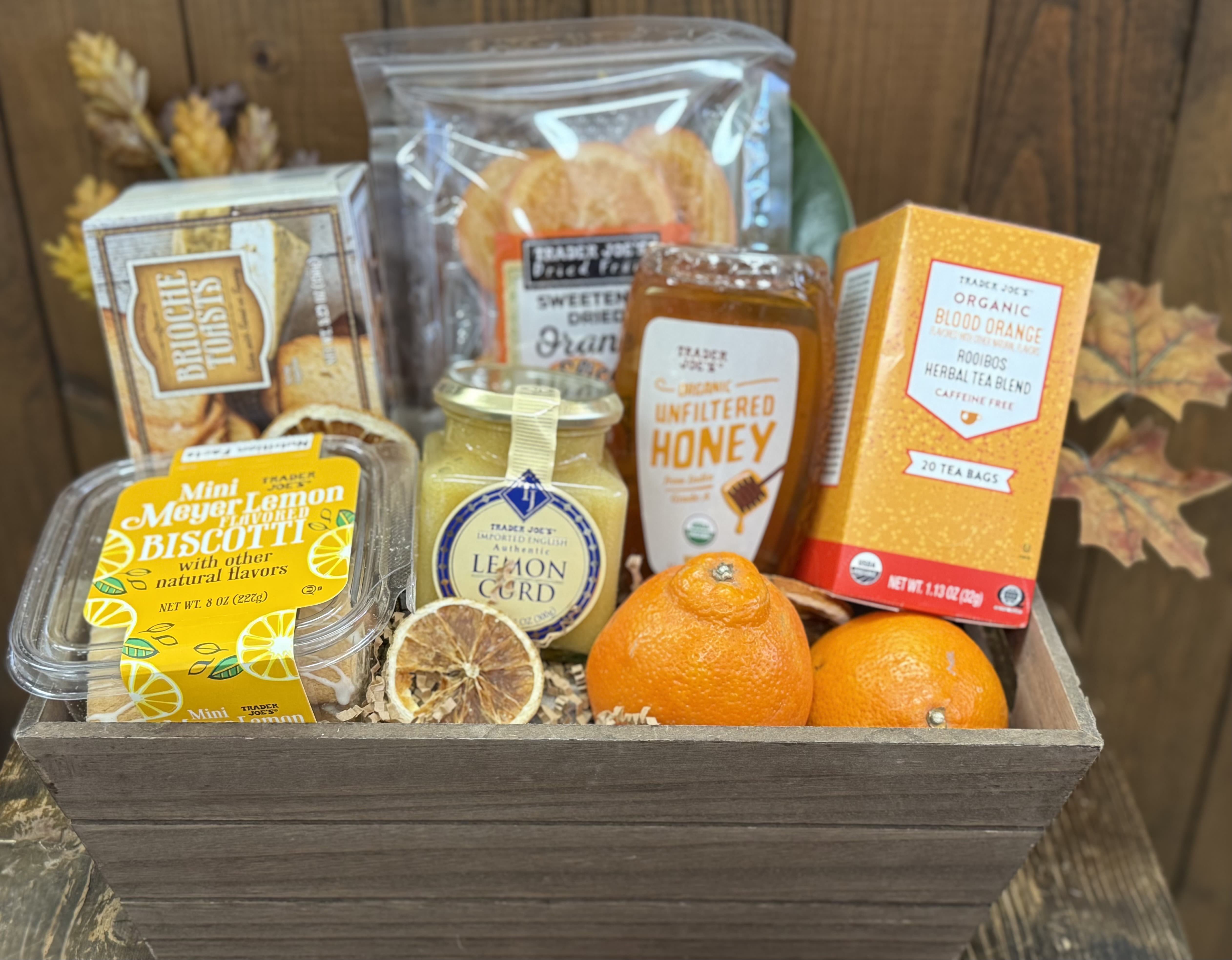 Gift basket with tea, honey, biscuits, lemon curd, and oranges