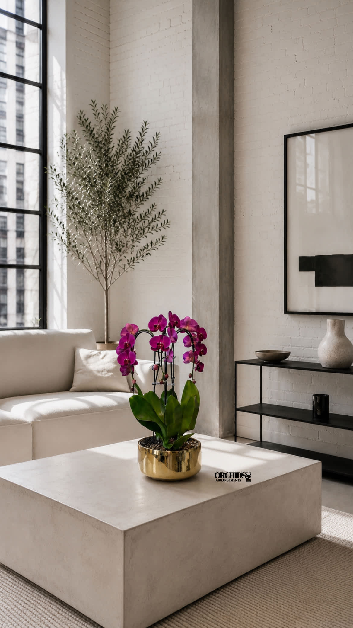 Potted purple orchids in a gold planter on a low table
