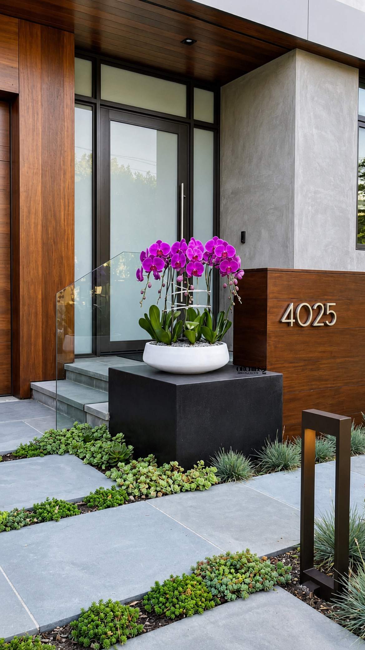 Potted purple orchids arranged in a white planter outside a modern home