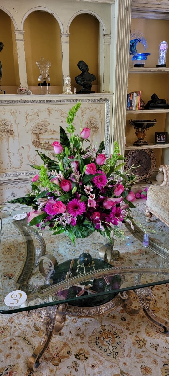 Pink floral arrangement with roses, lilies, and gerbera daisies in a low vase