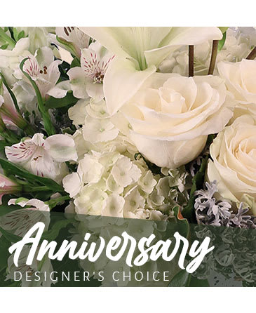White roses and lilies with hydrangeas in a floral arrangement