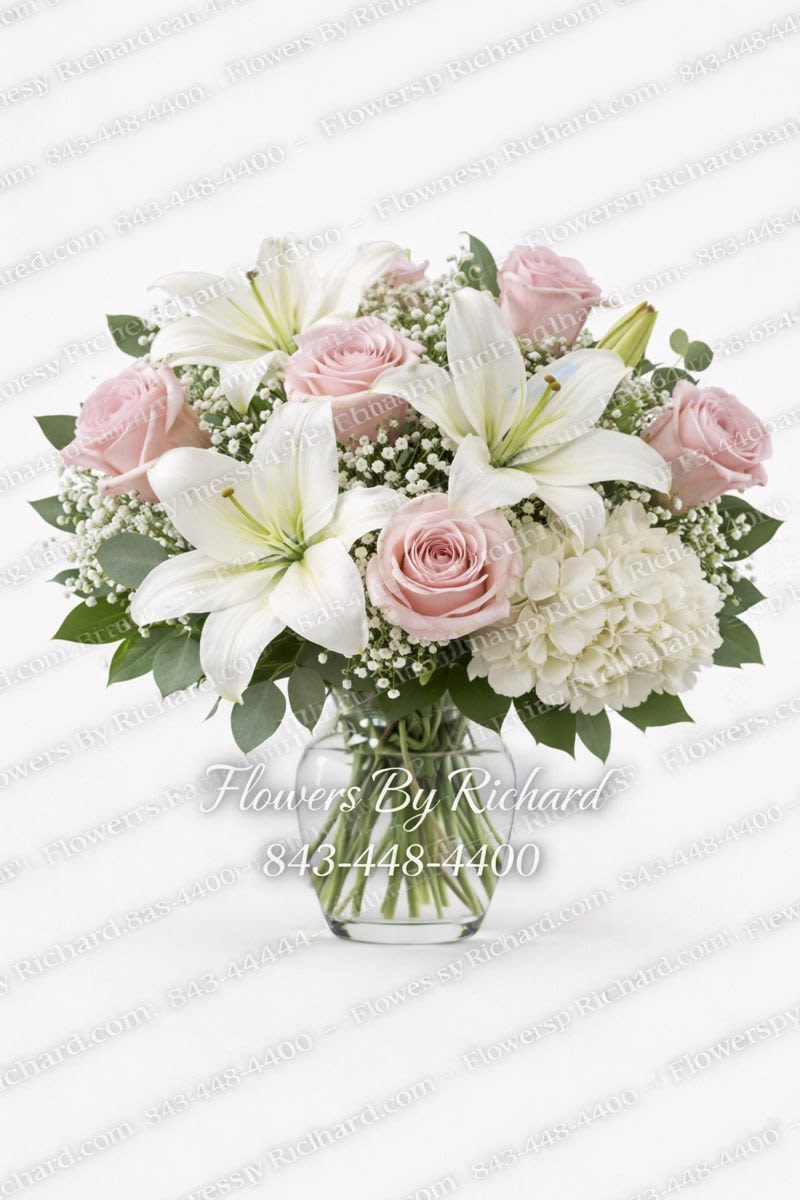 Pink roses and white lilies in a clear glass vase