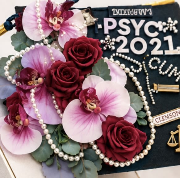 Luxe Orchid &amp; Rose Graduation Cap Decoration - Celebrate graduation in style with this elegant graduation cap decoration featuring vibrant red roses, blush pink orchids, pearl garlands, and greenery accents. Designed to transform any cap into a sophisticated statement piece, this floral design adds a luxurious and memorable touch to graduation day photos and celebrations.